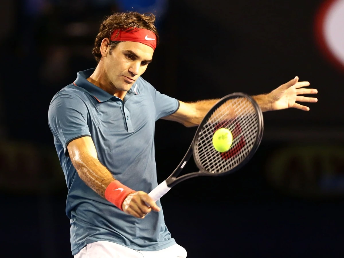 MELBOURNE, AUSTRALIA - JANUARY 20: Roger Federer of Switzerland plays a backhand in his fourth round match against Jo-Wilfried Tsonga of France during day eight of the 2014 Australian Open at Melbourne Park on January 20, 2014 in Melbourne, Australia. (Photo by Matt King/Getty Images)