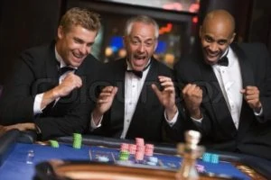 1236192-730952-group-of-men-celebrating-win-at-roulette-table-in-casino
