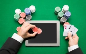 10694027-casino-poker-player-with-cards-tablet-and-chips