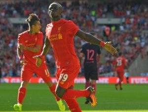 Liverpool's Senegalese midfielder Sadio Mane celebrates after scoring the opening goal of the pre-season International Champions Cup football match between Spanish champions, Barcelona and Liverpool at Wembley stadium in London on August 6, 2016. / AFP PHOTO / Glyn KIRK