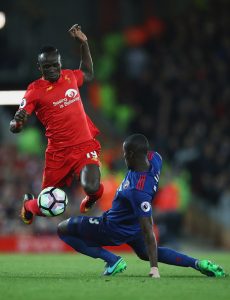 LIVERPOOL, ENGLAND - OCTOBER 17: Sadio Mane of Liverpool skips past Eric Bailly of Manchester United during the Premier League match between Liverpool and Manchester United at Anfield on October 17, 2016 in Liverpool, England. (Photo by Clive Brunskill/Getty Images)